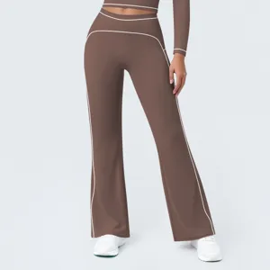 Brown high-waisted flared activewear yoga pants with contrast white piping detail.