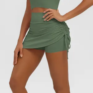 Detail view of olive green high-waist ruched activewear skirt shorts for fitness and yoga.