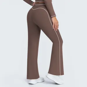 Brown high-waisted flare yoga pants detail, featuring elegant white contrast piping design.