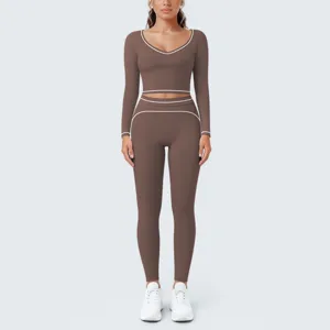 Brown long sleeve crop top and leggings yoga set detail with white contrast piping.
