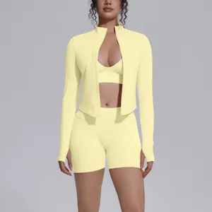 Seamless 3-piece athletic yoga set in butter yellow, featuring zip jacket, bra, and shorts.