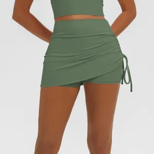 Green high-waist ruched faux two-piece yoga skirt shorts for fitness gym athletic wear.