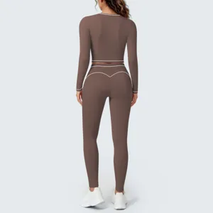 Back view detail of brown long sleeve crop top and leggings set with white contrast piping.
