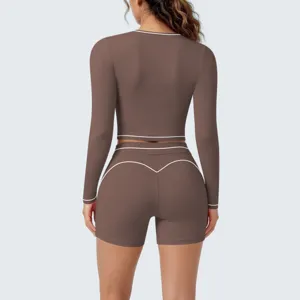 Brown long sleeve activewear set with white trim, ideal for fitness, running and yoga sessions.