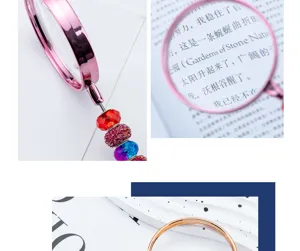 Handheld DIY beaded magnifying glass detail, clear optical lens, elegant pink reading tool.