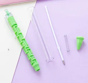 Detailed shot of disassembled creative maze ballpoint pen with green maze body and refill.