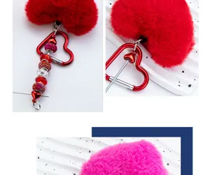 Detail view of DIY fluffy heart keychain with red and pink plush and beaded metal carabiner.