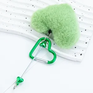 Green plush heart keychain with metal heart carabiner, cute fluffy bag charm and accessory.
