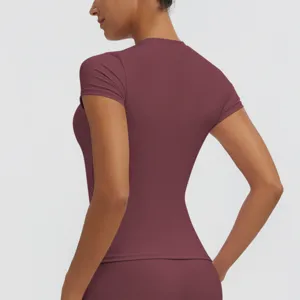 Detail view of women's maroon quick-dry short sleeve fitness top, slim fit design for yoga.