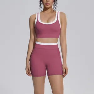 Detailed view of two-piece sports yoga set featuring contrast trim bra and high waist shorts.