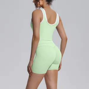 Detail view of women contrast color yoga tank top and biker shorts activewear set.