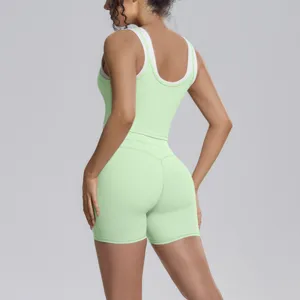 Close-up detail of the green contrast layered sports tank top and shorts yoga set.