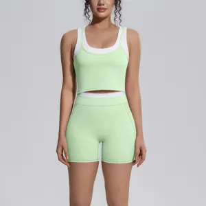 Close-up detail of light green and white two-piece yoga set, activewear fitness top and shorts.