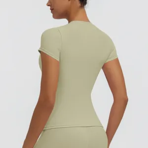 Detail view of women's short-sleeve fitness top in sage green, quick-drying yoga shirt.