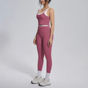 Women's two-piece yoga set featuring a contrast crop top and high-waisted leggings for fitness.
