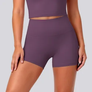 Close-up detail of high-waisted athletic yoga shorts and fitness crop top in plum purple.