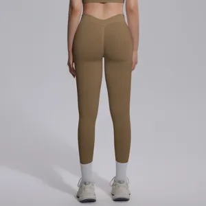 Back detail of seamless high-waist yoga leggings and sports bra set in solid brown color.