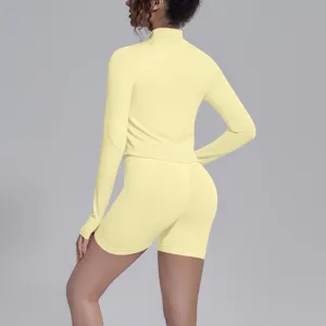 Seamless long sleeve activewear set detail view, high stretch yoga top and shorts.