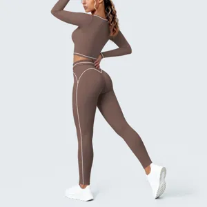 Women brown activewear set long sleeve crop top matching yoga leggings with white contrast piping.