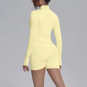 Seamless butter yellow activewear set long sleeve top and shorts for fitness and yoga.