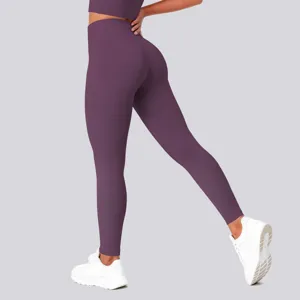 High waist yoga pants detail view showing stretchy purple fabric, tight fit, and body shaping.