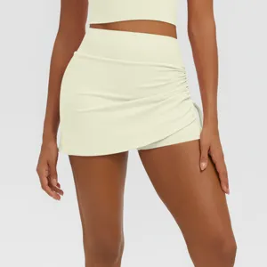 Close-up detail of high-waist ruched faux two-piece yoga skirt activewear for women workout fitness.