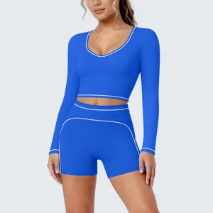 Blue long sleeve yoga crop top and shorts set with white piping, ideal for gym workout.