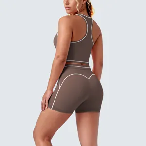 Detail view of brown contrast piping racerback sports bra and fitness shorts set.
