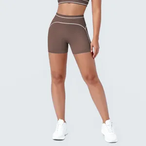 Detailfoto van bruine yoga korte broek met contrastende witte bies en hoge taille sportkleding.