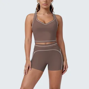 Brown yoga set features a cropped tank top and shorts with white contrast trim for fitness.