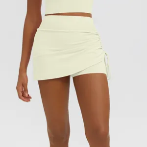 Detail view of the high-waisted pleated yoga skort, showing the side drawstring design.