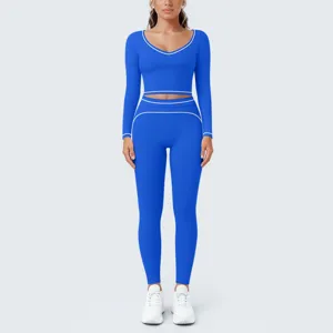 Blue long sleeve activewear set detail, contrast white piping crop top and leggings.
