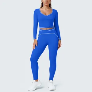 Royal blue yoga set detail showing long-sleeve crop top and tight leggings with white piping.