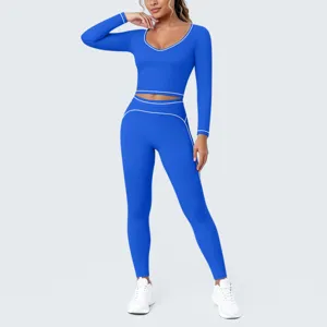 Royal blue long sleeve crop top and leggings yoga set detail, contrast white piping design.