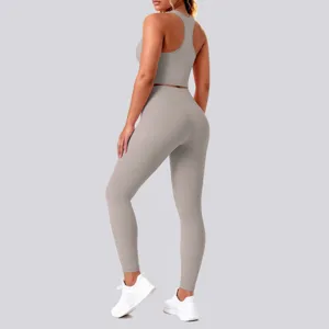Back view detail of grey athletic yoga set, seamless breathable tank top and high waist leggings.