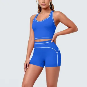 Women royal blue athletic yoga set featuring contrast piping, crop sports bra and shorts.
