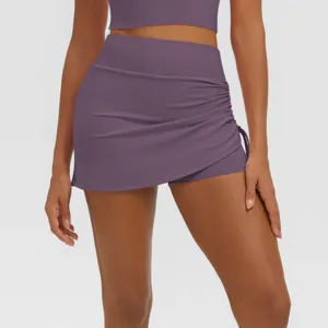 Detail view of purple high waist gathered fake two piece yoga skort for fitness and sports.