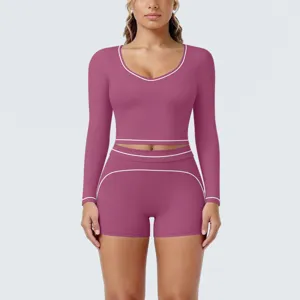 Long sleeve crop top and shorts fitness yoga set detail view, showing contrast piping design.