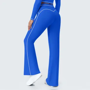 Detail shot of royal blue high-waisted flared yoga pants with contrast white piping.