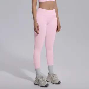 Detail shot of pink seamless yoga leggings and sports bra set for women fitness wear.