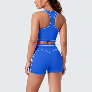 Detail view of royal blue athletic sports bra and yoga shorts set with white piping trim.