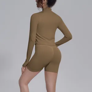 Detailed back view of seamless long sleeve activewear top and biker shorts in solid brown color.