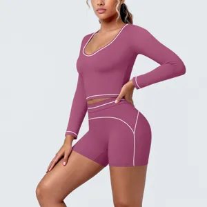 Detail view of the contrast-trimmed long sleeve activewear crop top and shorts set.