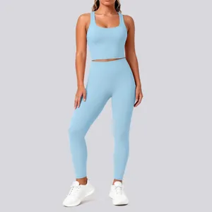 Solid color athletic yoga set featuring a breathable crop tank top and high-waisted leggings.