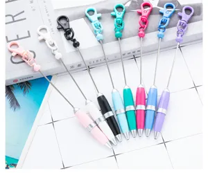 Colorful mini keychain pens close-up showing portable design and metal wire lanyards.