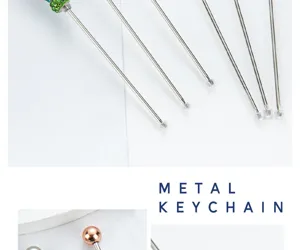Stainless steel cake testing needle with rhinestone handle and protective cap for baking tools.