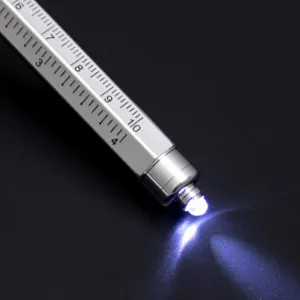 Multifunctional tool pen with built-in scale ruler and LED light, silver metallic finish.