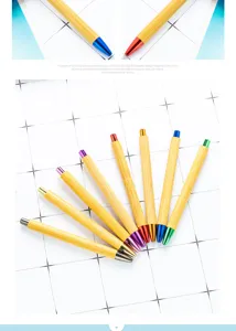Detailed close-up shot of eco-friendly bamboo ballpoint pens with colorful metal tips.