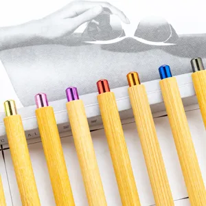 Eco-friendly bamboo ballpoint pen with colorful metallic push cap for hotel and office gift.