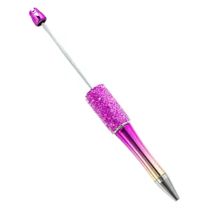 DIY beadable ballpoint pen with pink gradient metal body, rhinestone glitter and top pin.